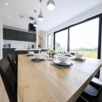 Dining table beside large windows in the Broadford LH702PD