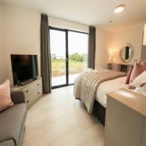 Bedroom with glazed doors to the garden in the Broadford LH702PD